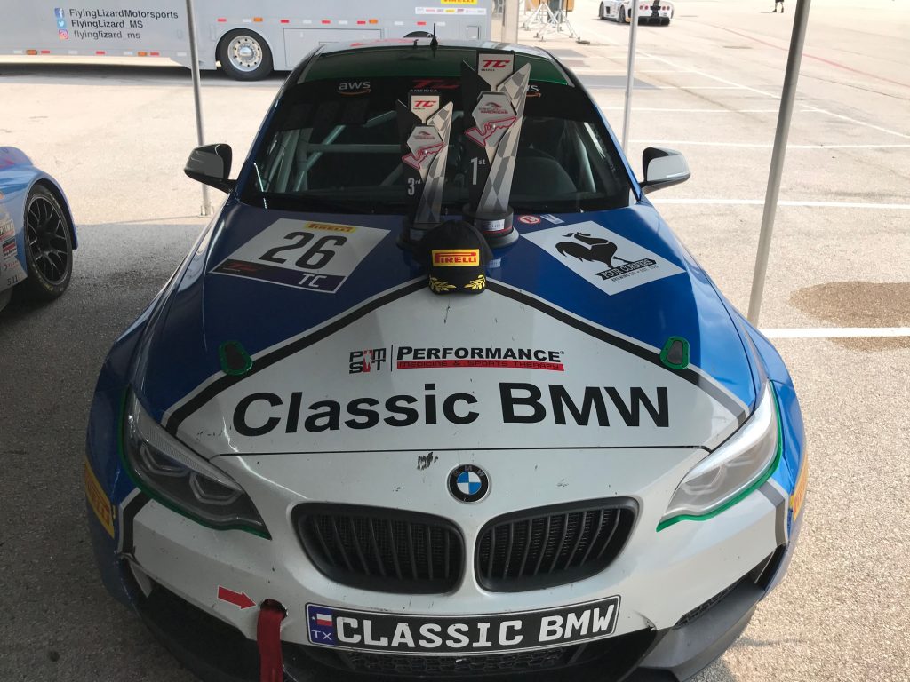 Classic BMW No. 26 TC car with race trophies on the hood