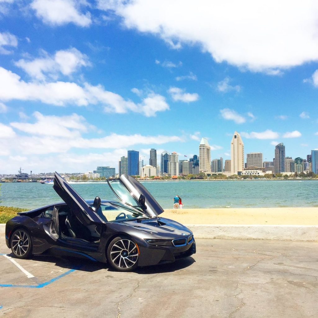BMW i8 parked on the San Diego waterfront with the downtown skyline in the background
