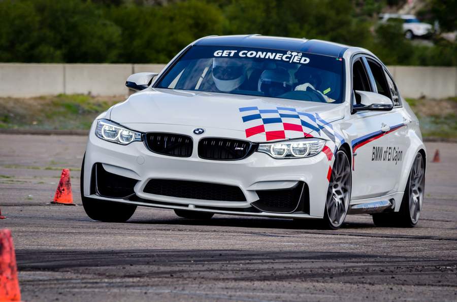 White BMW M3/M4 autocross car with BMW of El Cajon and Get Connected livery